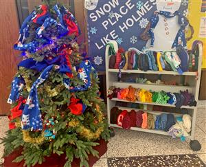 tree full of hats and scarves and a shelf with mittens and hats